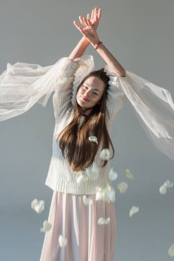 mutlu çekici kadın moda kış kıyafeti ayakta gri izole düşen yaprakları altında