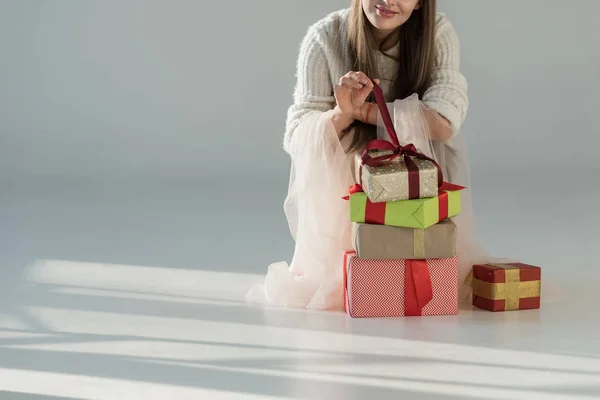 Cropped Image Woman Fashionable Winter Outfit Squatting Gift Boxes Opening — 스톡 사진
