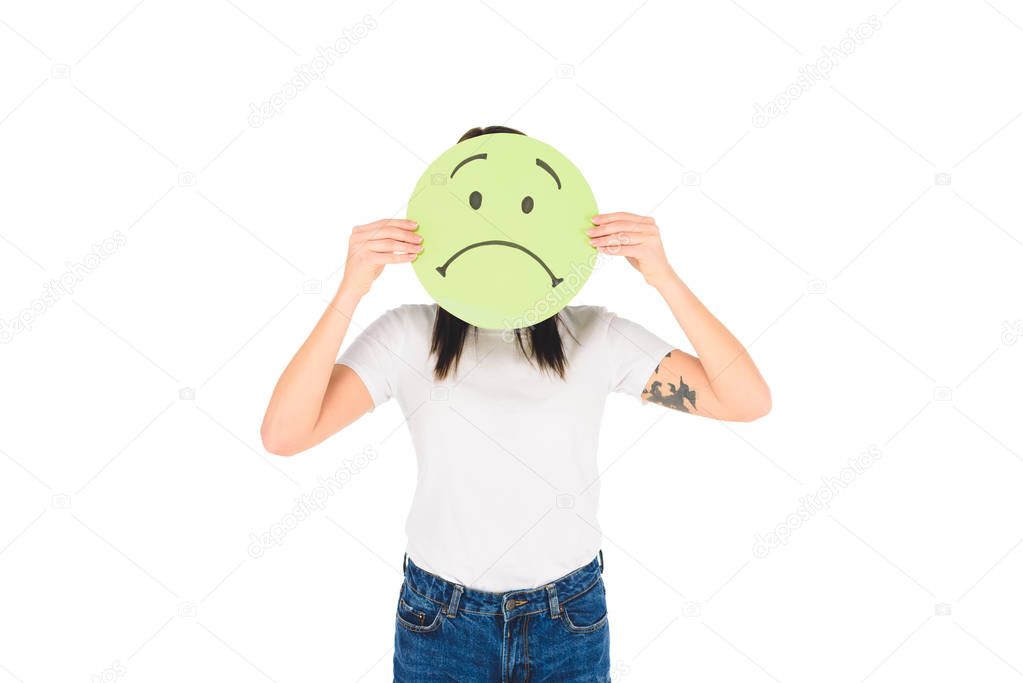 woman holding green sign with sad face expression isolated on white