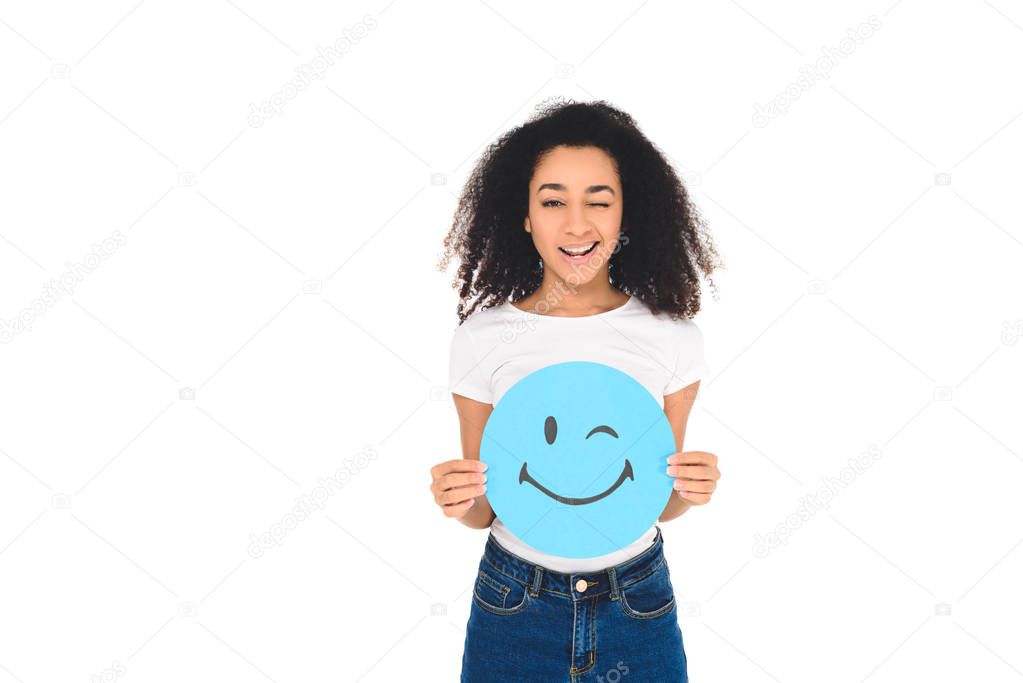 african american girl holding sign with winking face expression isolated on white