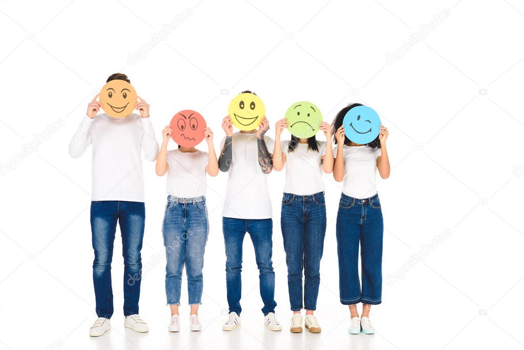 young multicultural friends in white t-shirts holding colored cards isolated on white 