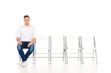 cheerful smiling man sitting alone isolated on white clipart