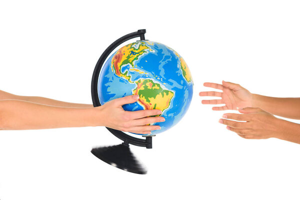cropped view of woman giving globe to african american girl isolated on white