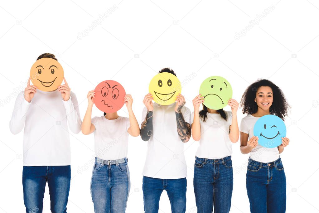 young multicultural friends in white t-shirts holding signs with face expressions isolated on white