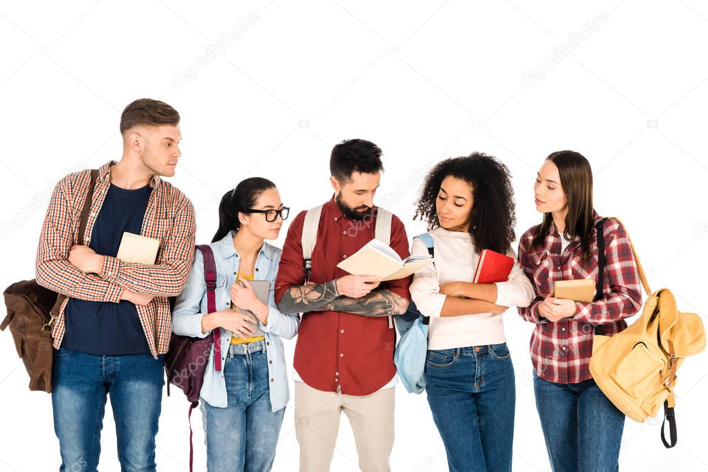 multicultural group of people looking at book in hands of handsome man  isolated on white