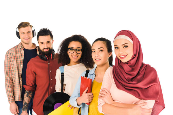 multicultural group of young people standing and smiling  isolated on white 