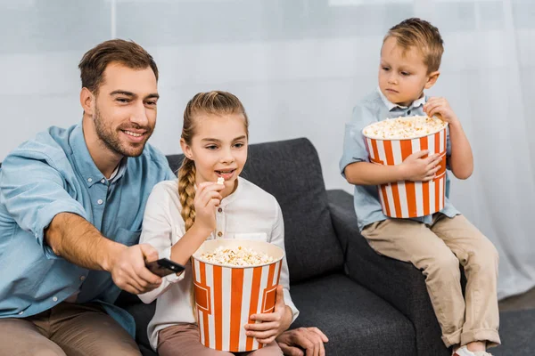 Smiling Father Sitting Sofa Changing Channels Remote Controller Children Holding — Stock Photo, Image