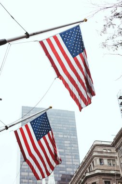 urban scene with national american flags on street, new york, usa clipart