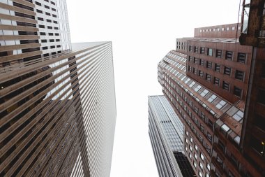 bottom view of skyscrapers and clear sky in new york city, usa clipart