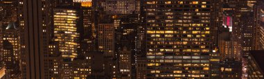 panoramic view of buildings and night city lights in new york, usa clipart