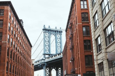 urban scene with buildings and brooklyn bridge in new york city, usa clipart