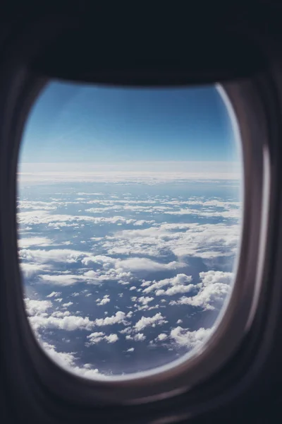 view of blue cloudy sky from airplane window
