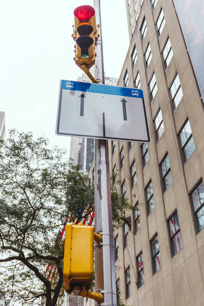 urban scene with buildings, traffic light and road sign in New york city, usa
