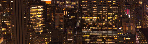 Panoramic view of buildings and night city lights in new york, usa