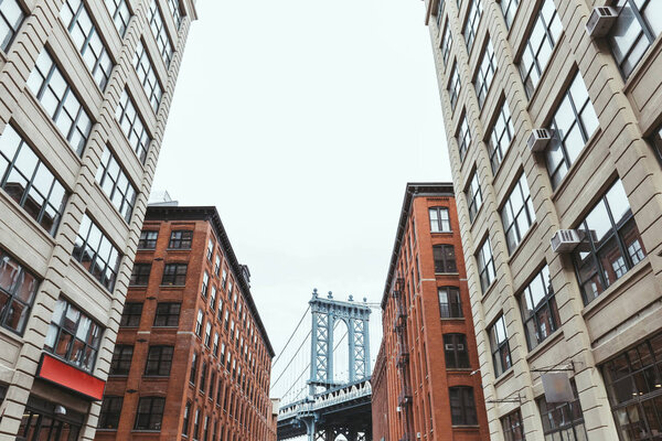 Urban scene with buildings and brooklyn bridge in new york city, usa