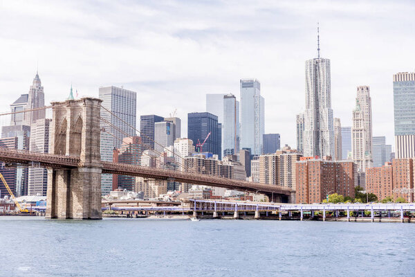 Urban scene with brooklyn bridge and manhattan in new york, usa