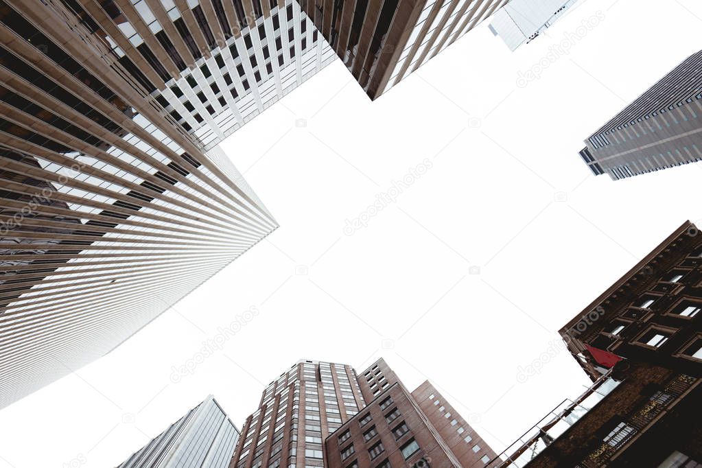 bottom view of skyscrapers and clear sky in new york city, usa