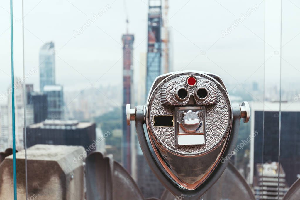 close up view of operated binoculars on observation deck in new york city, usa