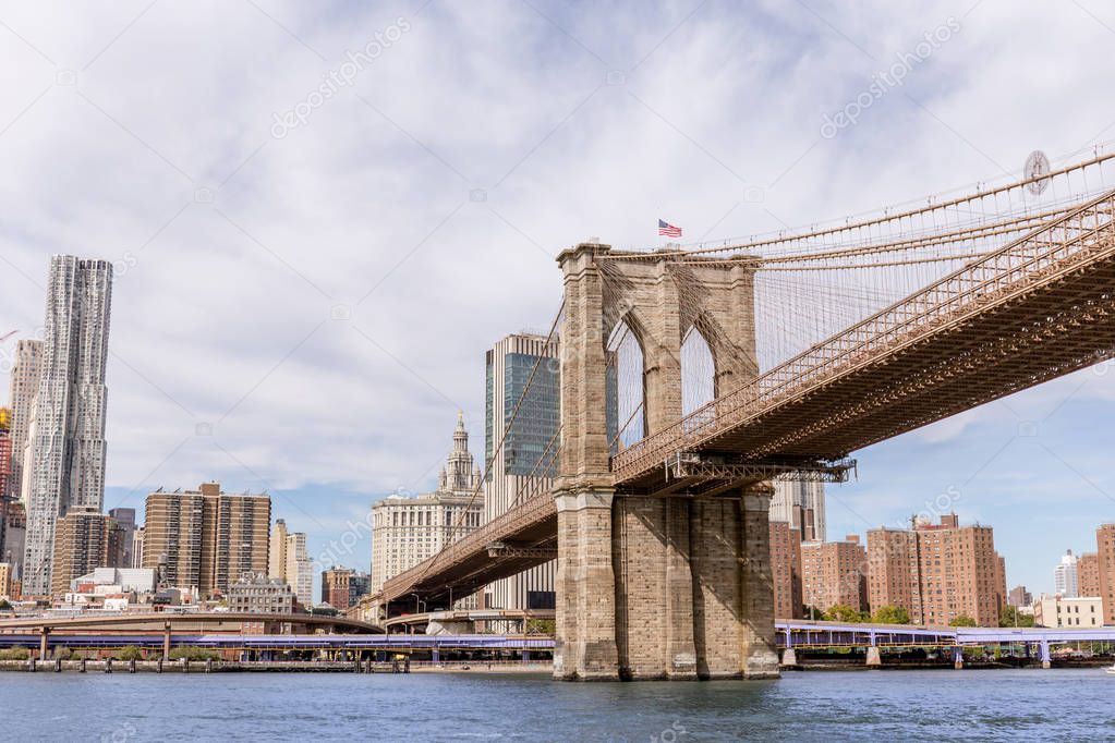 urban scene with brooklyn bridge and manhattan in new york, usa