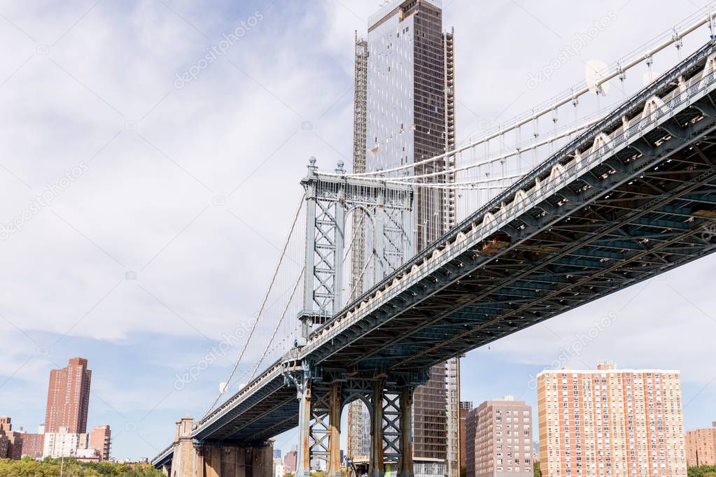 urban scene with brooklyn bridge and manhattan in new york, usa