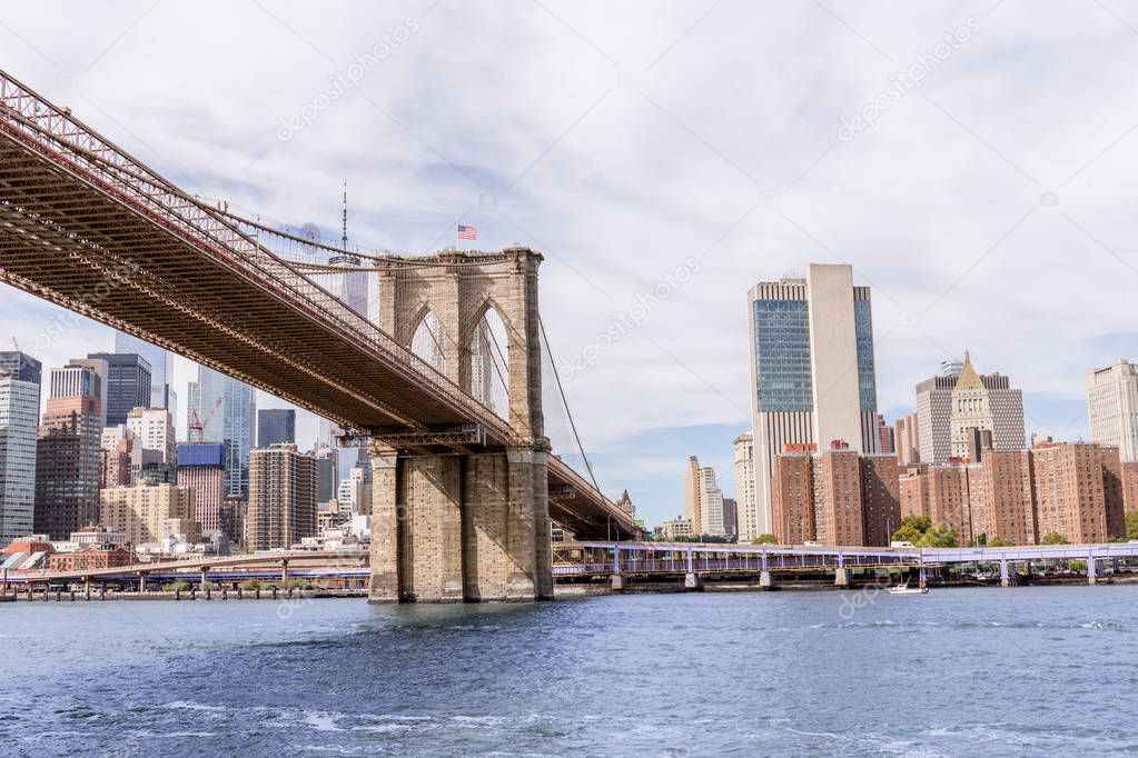 urban scene with brooklyn bridge and manhattan in new york, usa