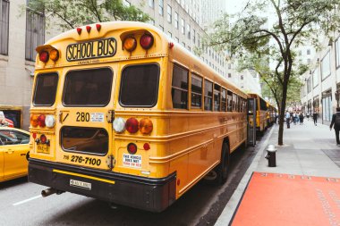 NEW YORK, USA - OCTOBER 8, 2018: close up view of school buses parked on street, new york, usa clipart