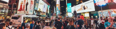 TIMES SQUARE, NEW YORK, USA - OCTOBER 8, 2018: panoramic view of crowded times square in new york at night, usa clipart