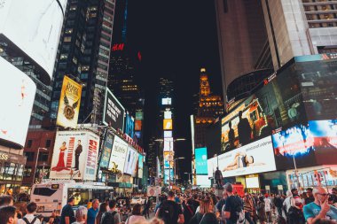TIMES SQUARE, NEW YORK, USA - OCTOBER 8, 2018: urban scene with crowded times square in new york at night, usa clipart
