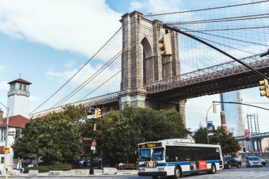 NEW YORK, USA - OCTOBER 8, 2018: urban scene with brooklyn bridge and new york city street, usa clipart