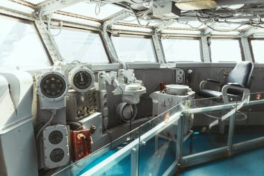 NEW YORK, USA - OCTOBER 8, 2018: close up view of empty captain chair and marine equipment in ship clipart
