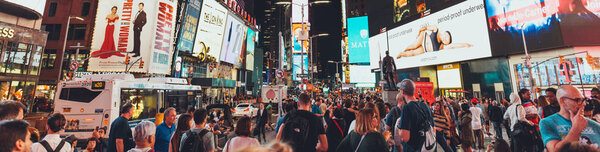 TIMES SQUARE, NEW YORK, USA - OCTOBER 8, 2018: panoramic view of crowded times square in new york at night, usa