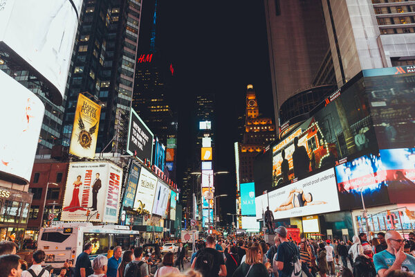 TIMES SQUARE, NEW YORK, USA - OCTOBER 8, 2018: urban scene with crowded times square in new york at night, usa