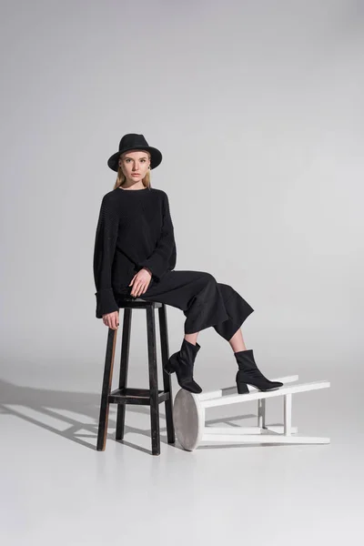 Attractive Caucasian Blonde Woman Black Clothes Hat Sitting Chair Looking — Stock Photo, Image