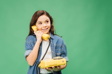 cute smiling child talking on vintage telephone isolated on green clipart