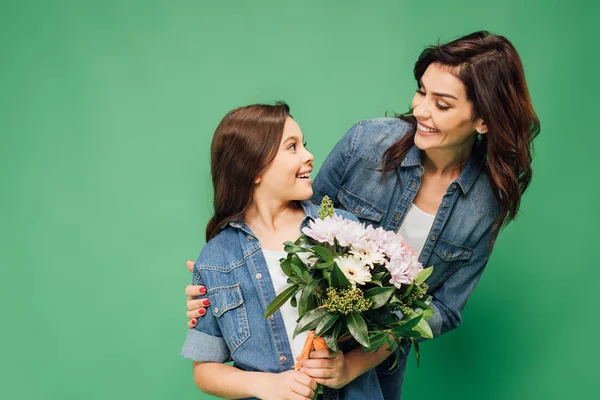 Beautiful Smiling Mother Embracing Daughter Flower Bouquet Isolated Green — Stock Photo, Image