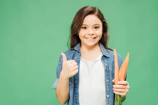 Happy Child Holding Carrots Showing Thumb Sign Isolated Green — Stock Photo, Image