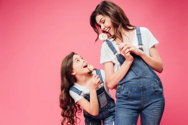 Mãe Alegre Filha Segurando Pirulitos Isolados Rosa — Fotografia de Stock