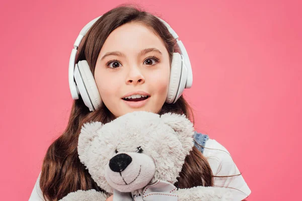 Excited Child Headphones Holding Teddy Bear Isolated Pink — Stock Photo, Image