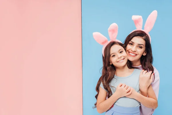 Beautiful Woman Bunny Ears Hugging Child Smiling Camera Blue Pink — Stock Photo, Image