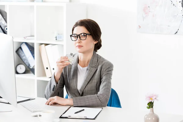 Attractive Businesswoman Sniffing Jar Perfume Office — Stock Photo, Image