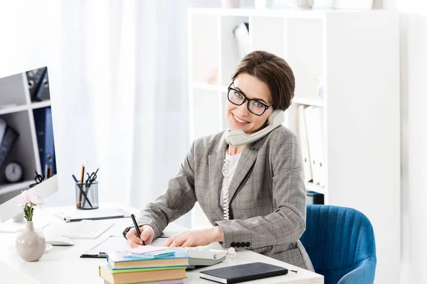 Smiling Attractive Businesswoman Talking Stationary Telephone Office Looking Camera — Stock Photo, Image