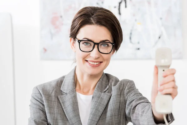 Smiling Attractive Businesswoman Glasses Showing Stationary Telephone Handset Office — Stock Photo, Image