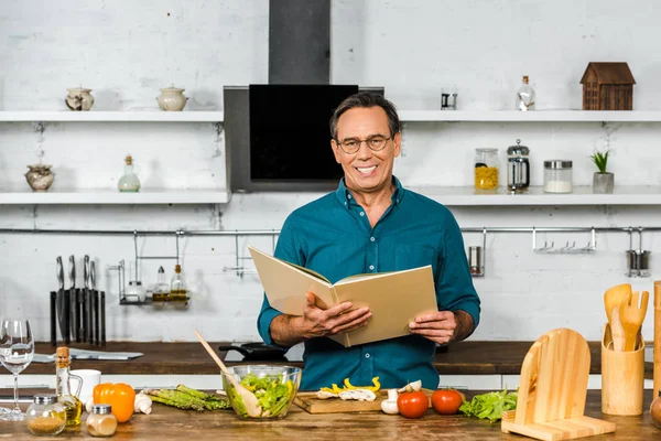 Bonito Maduro Homem Cozinhar Cozinha Segurando Livro Receitas — Fotografia de Stock