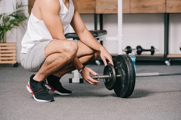 Cropped View Man Sitting Barbell Putting Heavy Disk — Stock Photo, Image