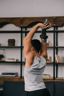 adam holding dumbbell Merkez over 