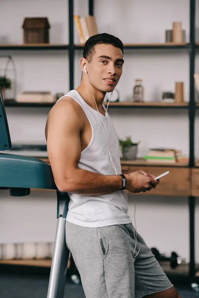 Handsome Racial Man Holding Smartphone While Listening Music — Stock Photo, Image