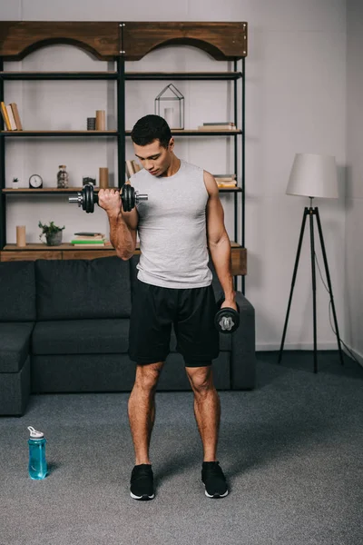 Mixed Race Man Looking Muscles Hand While Doing Exercise Living — Stock Photo, Image