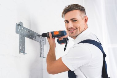 Yetişkin tamirci braket için klima matkap ile yükleme gülümseyen