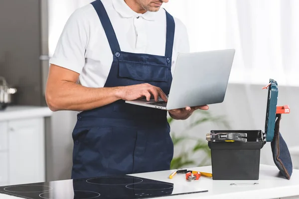 Cropped View Adult Repairman Using Laptop While Repairing Electric Stove — Stock Photo, Image