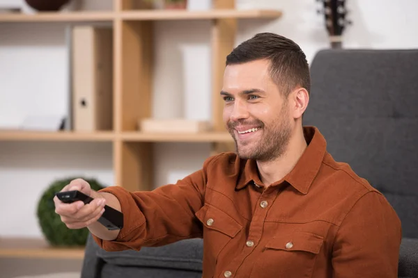 Cheerful Man Holding Remote Control Smiling Home — Stock Photo, Image